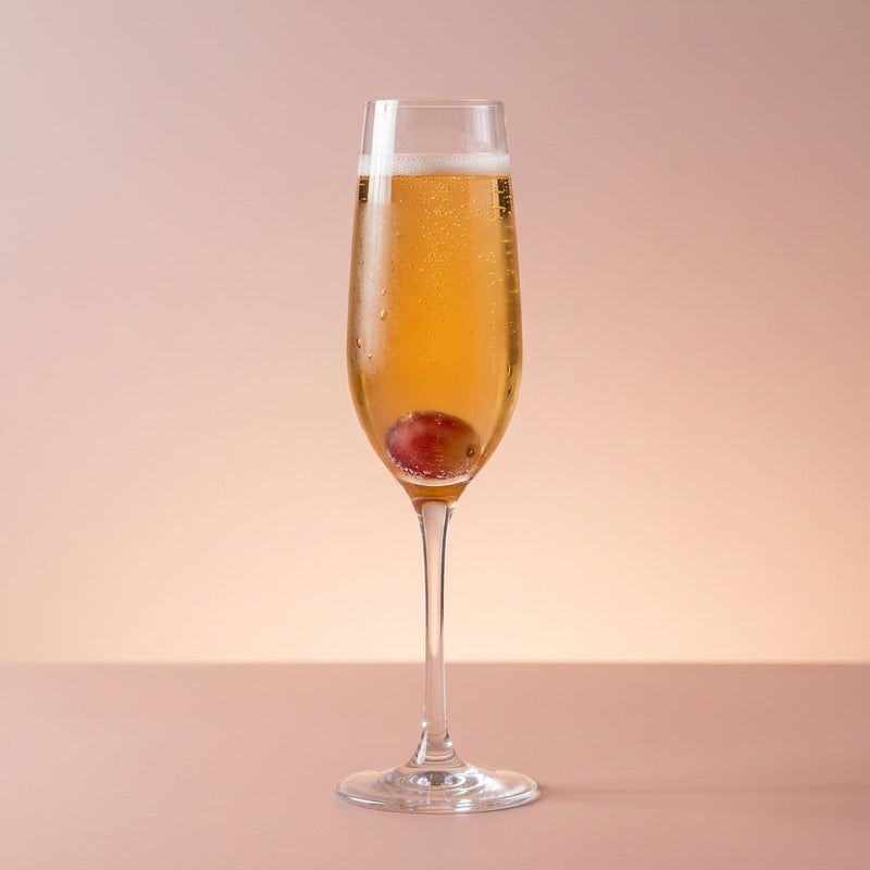 A photo of the Pisco Petal cocktail containing Red grapes, 1615 Pisco Puro Quebranta, Freshly squeezed lemon juice, Giffard Sugar Cane Syrup (Sirop Sucre de Canne), Perrier Jouet Grand Brut Champagne in a Flute.