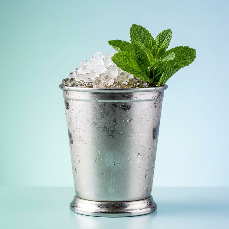 A photo of the Cognac Julep cocktail containing Mint leaves, Hennessy V.S. Cognac, Giffard Sugar Cane Syrup (Sirop Sucre de Canne) in a Julep Tin.