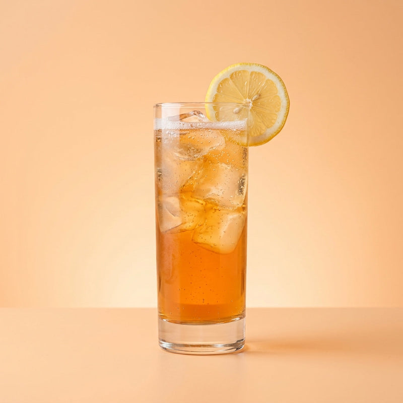 A photo of the Alabazam cocktail containing Hennessy V.S. Cognac, Grand Marnier, Freshly squeezed lemon juice, Giffard Sugar Cane Syrup (Sirop Sucre de Canne), Angostura Orange Bitters, Club soda in a Collins.