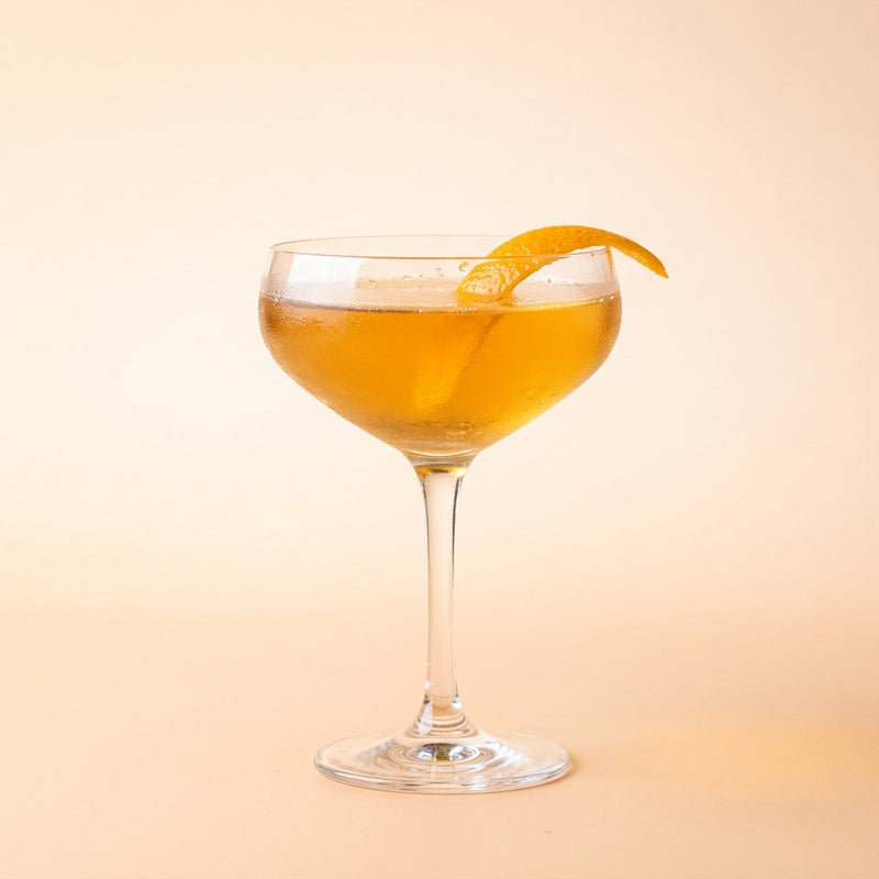 A photo of the The Franco-British Handshake cocktail containing Hennessy V.S. Cognac, Beefeater London Dry Gin, Suze Aperitif, Freshly squeezed lemon juice, Giffard Sugar Cane Syrup (Sirop Sucre de Canne) in a Coupe.