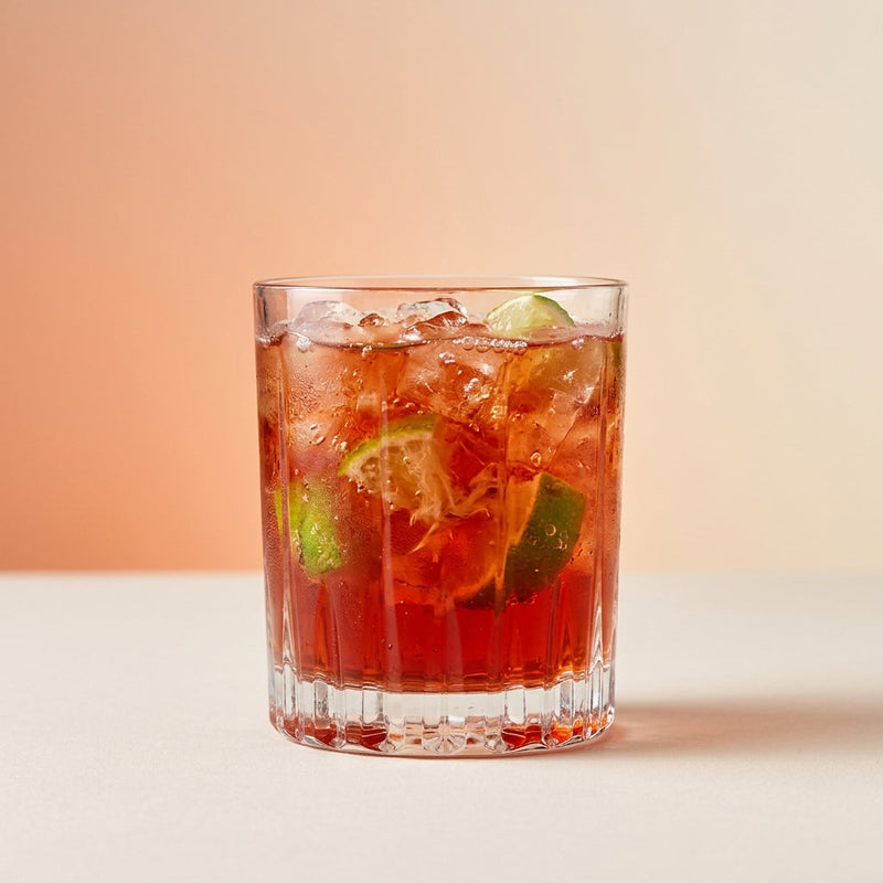 A photo of the Campari Caipirinha Crush cocktail containing Fresh lime (chopped wedges), Campari Aperitivo, Giffard Sugar Cane Syrup (Sirop Sucre de Canne) in a Old-Fashioned.