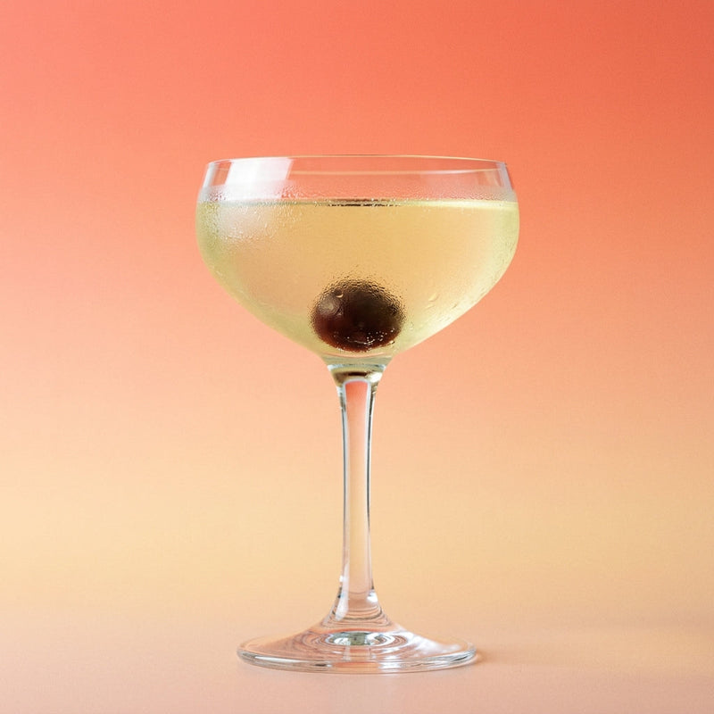 A photo of the The Floral Fix cocktail containing Beefeater London Dry Gin, St-Germain Elderflower Liqueur, Freshly squeezed lemon juice, Giffard Sugar Cane Syrup (Sirop Sucre de Canne) in a Coupe.