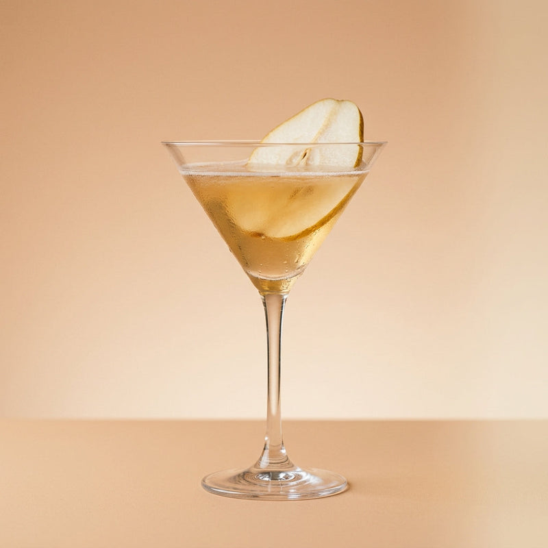 A photo of the Pear of the Ritz cocktail containing Etter Pear Williams Eau de Vie, Zubrowka Bison Grass Vodka, Pressed apple juice, Giffard Sugar Cane Syrup (Sirop Sucre de Canne) in a Martini.