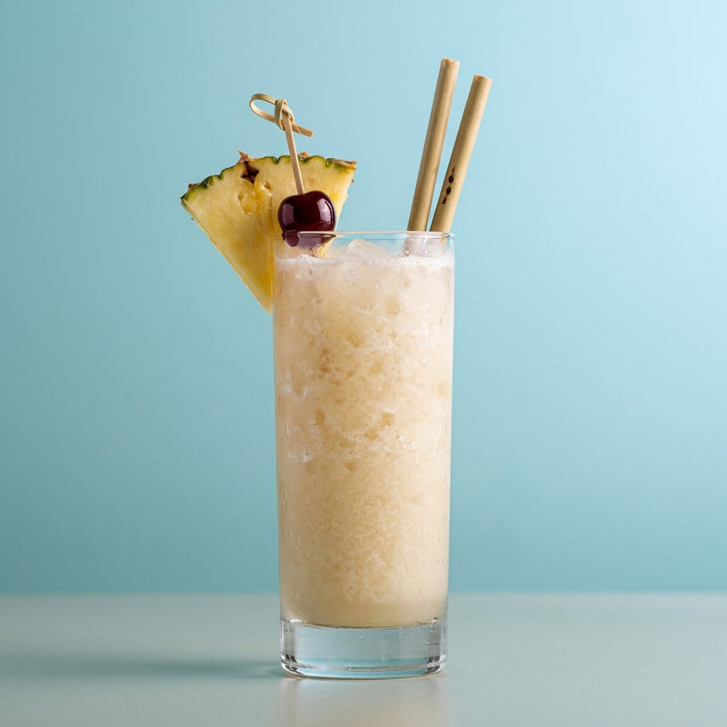 A photo of the Frozen Falernum Colada cocktail containing Planteray 3 Stars White Rum, Flor de Caña 4 Year Old Añejo Oro Rum, John D. Taylor's Velvet Falernum, Freshly squeezed lime juice, Giffard Sugar Cane Syrup (Sirop Sucre de Canne) in a Collins.