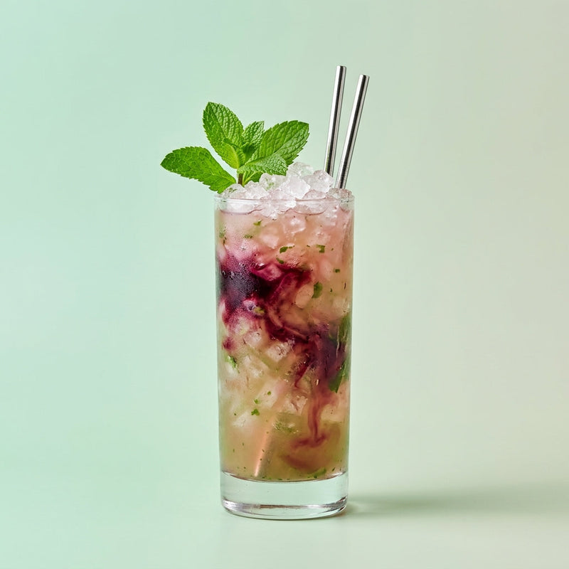 A photo of the Bramble Basil Gin Sling cocktail containing Basil leaves, Beefeater London Dry Gin, Freshly squeezed lemon juice, Giffard Sugar Cane Syrup (Sirop Sucre de Canne), Combier Crème de Mûre Blackberry Liqueur in a Sling.