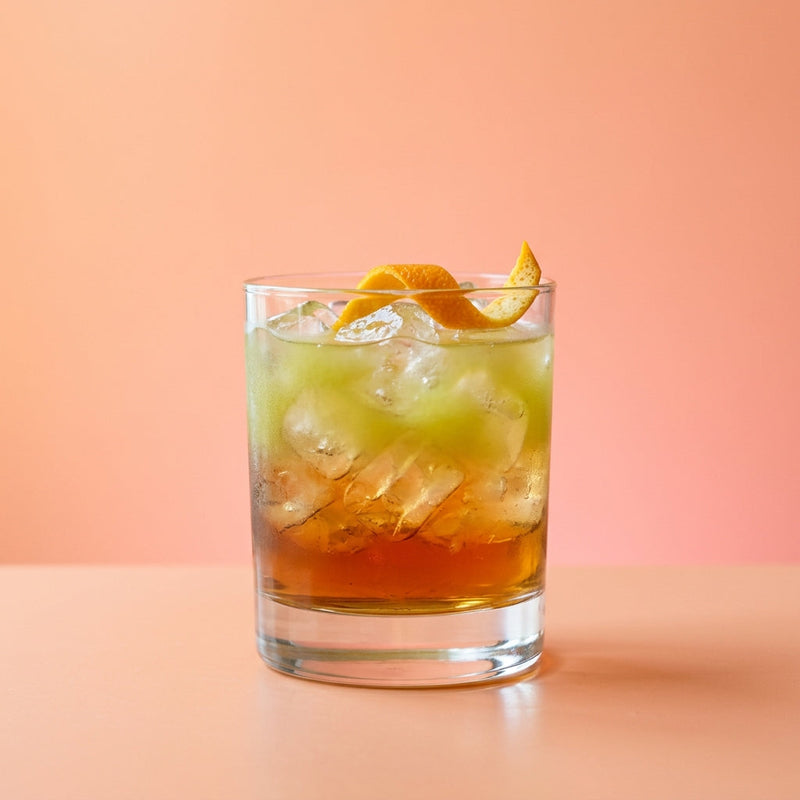 A photo of the Jamaican Sunset Old Fashioned cocktail containing Smith & Cross Traditional Jamaica Rum, Giffard Sugar Cane Syrup (Sirop Sucre de Canne), Pressed apple juice, Angostura Aromatic Bitters in a Old-Fashioned.