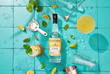 Planteray 5 Stars gin bottle with cocktail ingredients on a turquoise tiled background