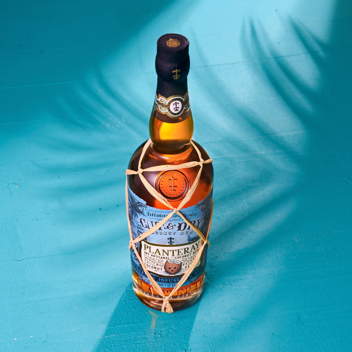 Bottle of Planteray Cut & Dry on a blue background