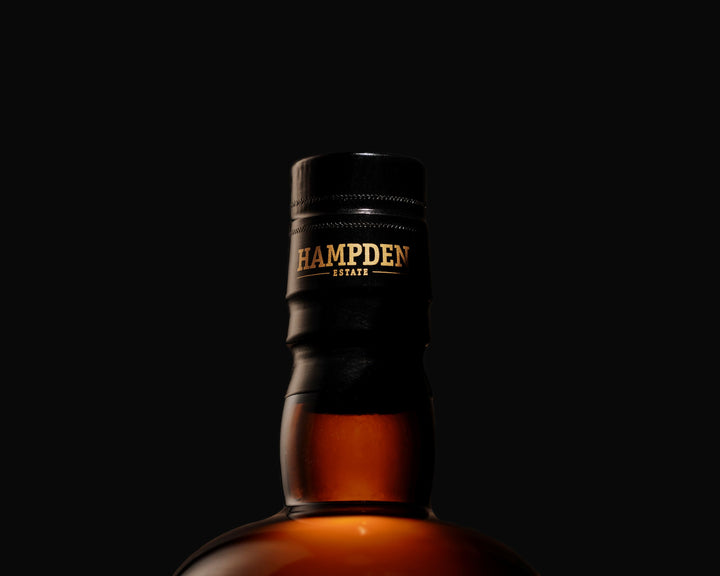 Bottle of Hampden Estate rum against a black background
