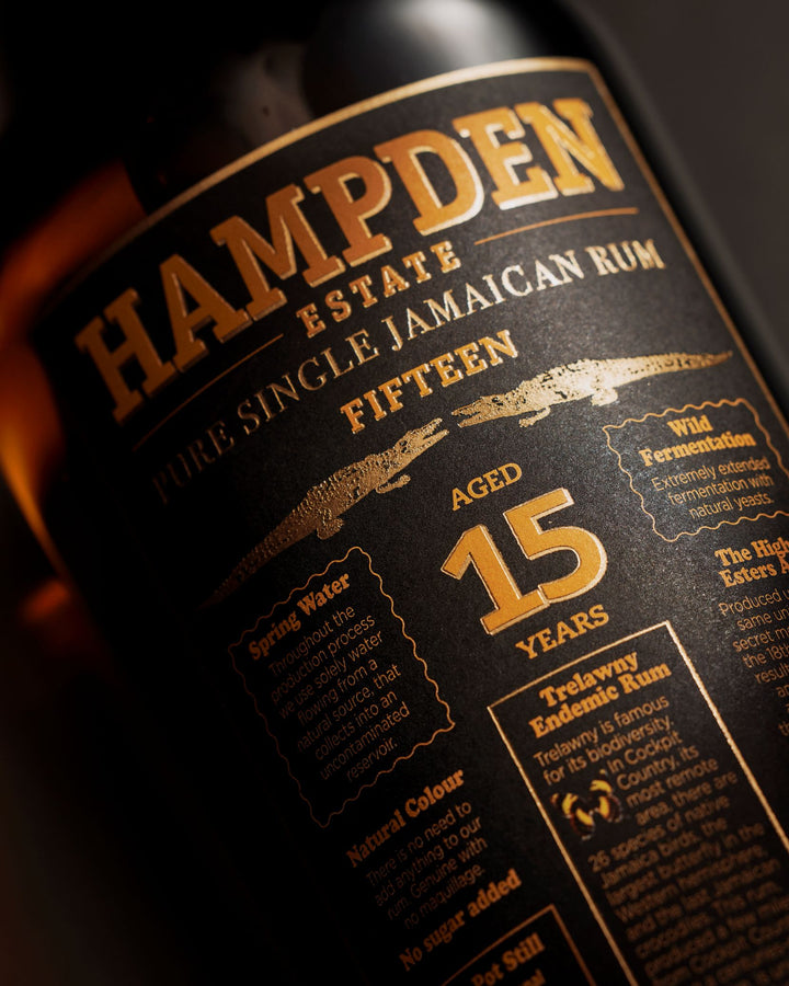 Hampden Estate 15-year-old Jamaican rum bottle label with gold text on a dark background
