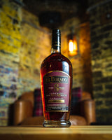 El Dorado rum bottle on a wooden surface with a blurred bar background