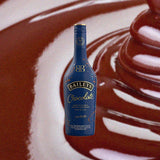 Bottle of Baileys Chocolate Irish Cream Liqueur over backdrop of melted chocolate.