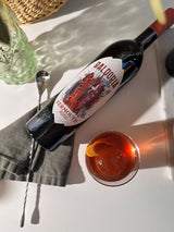 Bottle of Baldoria Vermouth Rosso with a glass of the drink on a white surface.