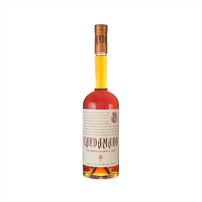A tall bottle with a thin neck. The liquid is a pleasing orange yellow color. The label looks like old-fashioned manuscript and reads: Cardamaro.  There is a hand-drawn image of a thistle in the upper right corner. 