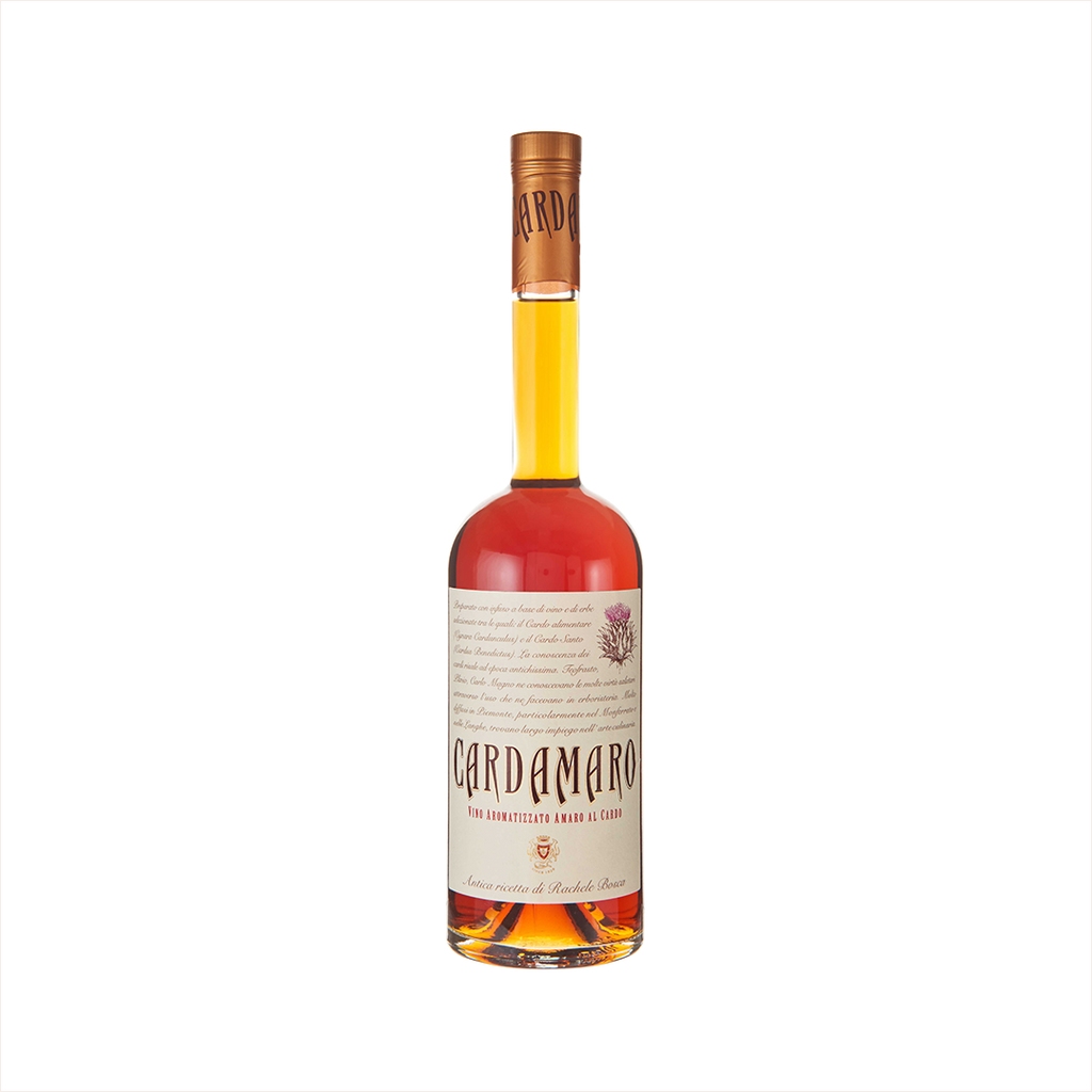 A tall bottle with a thin neck. The liquid is a pleasing orange yellow color. The label looks like old-fashioned manuscript and reads: Cardamaro.  There is a hand-drawn image of a thistle in the upper right corner. 
