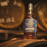 Chairman's Reserve Rum bottle on a wooden barrel with blurred barrels in the background