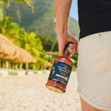 Person holding a bottle of Chairman's Reserve Rum on a tropical beach.