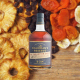 Bottle of Chairman's Reserve The Forgotten Casks Rum over backdrop image of dried candies and fruits.