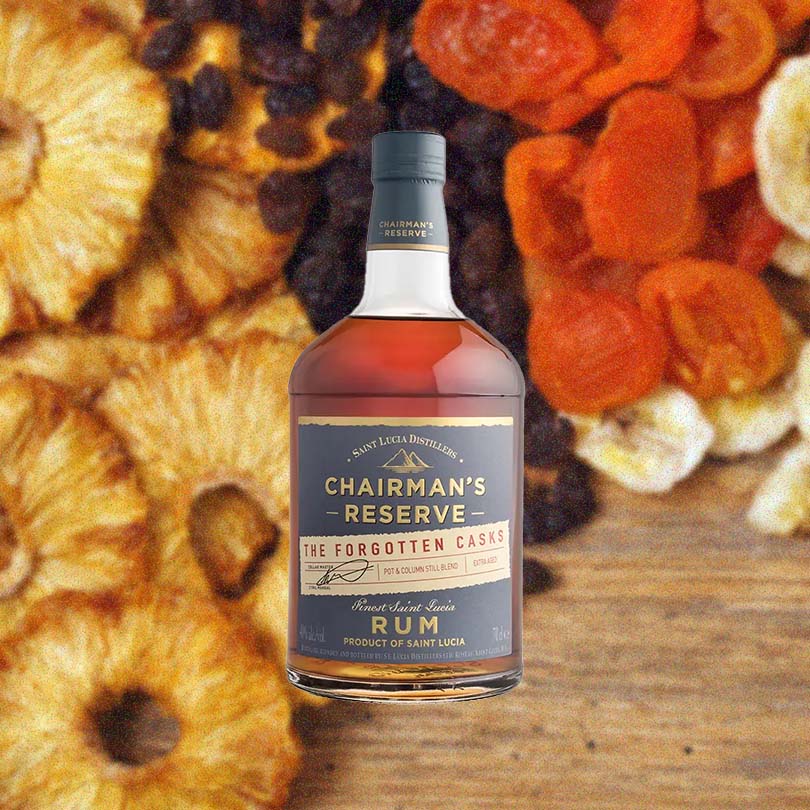 Bottle of Chairman's Reserve The Forgotten Casks Rum over backdrop image of dried candies and fruits.