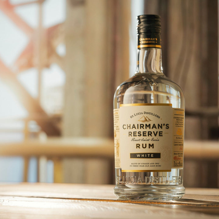 Chairman's Reserve Rum bottle on a wooden surface with blurred background