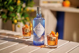 Citadelle gin bottle with a cocktail on a wooden table
