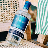 Bottle of Clément rum on a wooden surface with a blurred background