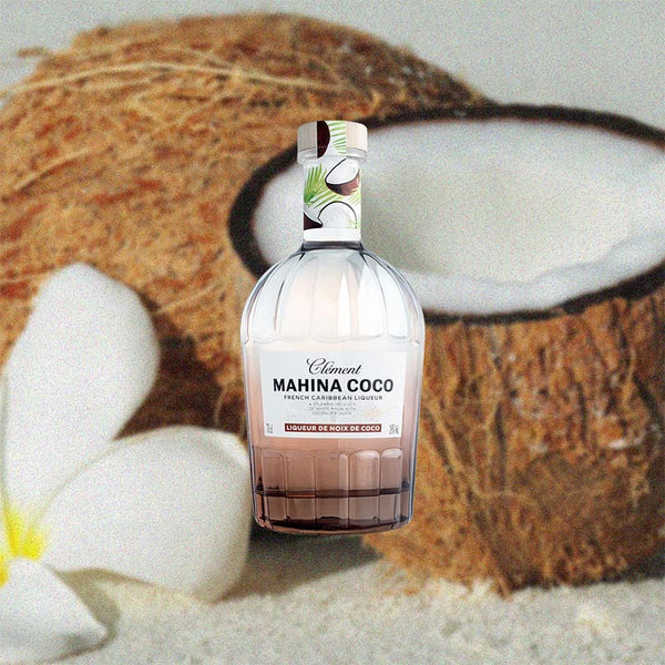 Bottle of Rhum Clement Mahina Coco Liqueur over back drop image of coconuts.