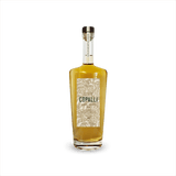 An elegant looking bottle of caramel colored liquid with a label that reads Copalli Barrel Rested Rum against a backdrop of illustrated rainforest flora and fauna.