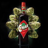 Bottle of Cynar surrounded by artichokes on a black background