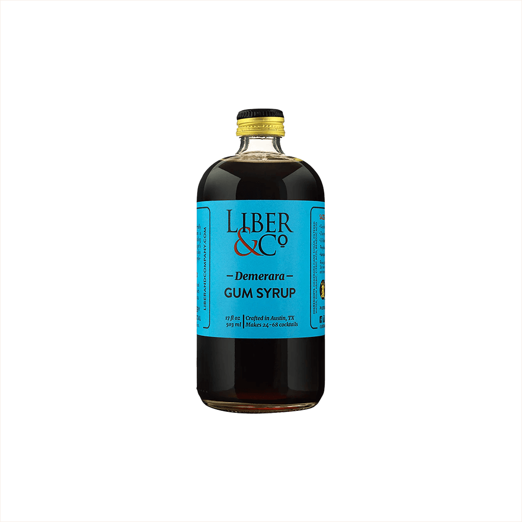 A large bottle of dark syrup with a canary blue label that reads: Liber & Co Demerara Gum Syrup.