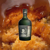 Bottle of Diplomatico Reserva Exclusiva Rum over backdrop of baked goods.
