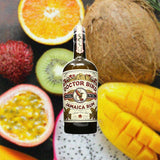 Bottle of Two James Doctor Bird Moscatel Cask Finish Rum over backdrop image of fruits on a table.