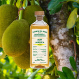 Bottle Image for Down Island Spirits Jamaica HD 2022 Rum against backdrop of tropical fruits on a tree