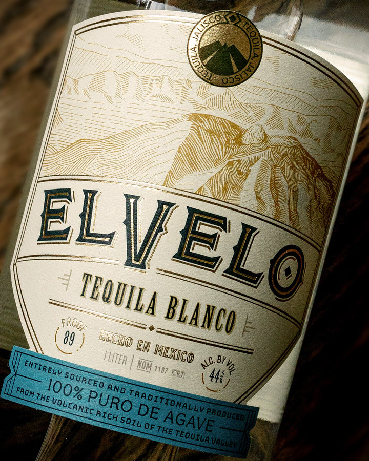 Elvelo Tequila Blanco bottle label with scenic design and branding elements.