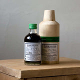 Bottle of Chartreuse Vegetal de La Grande (Chartreuse Elixir Vegetal) on a wooden table.