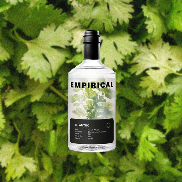 Bottle of Empirical Cilantro over back drop image of Cilantro.