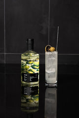 Bottle of Empirical gin with a cocktail on a black reflective surface
