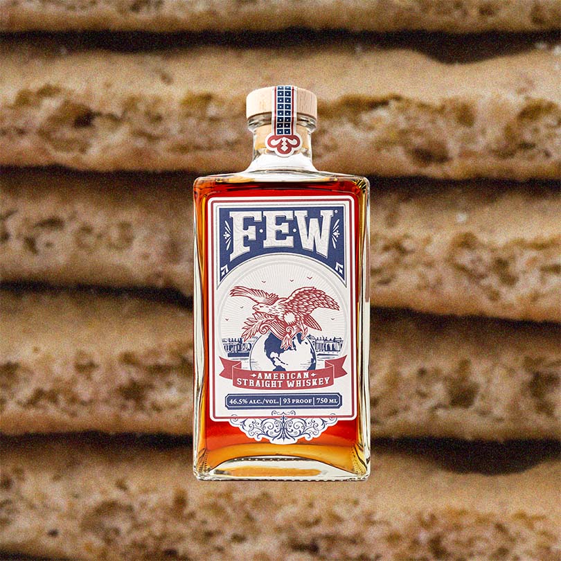 Bottle of FEW American Straight Whiskey over backdrop image of stacked graham crackers.