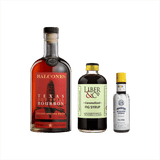 Bottles of Balcones Texas Pot Still Bourbon, Liber & Co. Caramelized Fig Syrup, and Angostura Aromatic Bitters.
