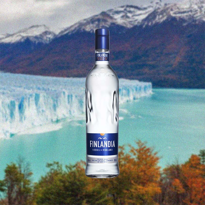 Bottle of Finlandia Vodka over backdrop image of an ice berg near mountains.