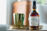 Foursquare whiskey bottle on a table with a blurred background