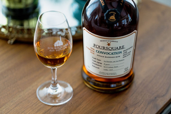 Foursquare whisky bottle and glass on a wooden surface