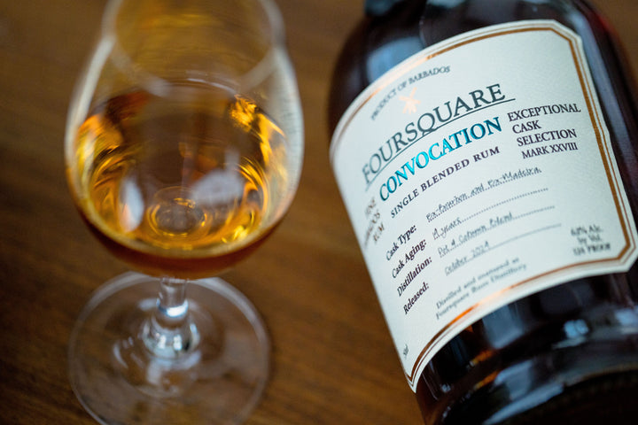 Boursquare Convocation rum bottle and glass on a wooden surface
