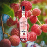 Bottle of Giffard Lichi-Li Liqueur over backdrop image of fruit, plants.