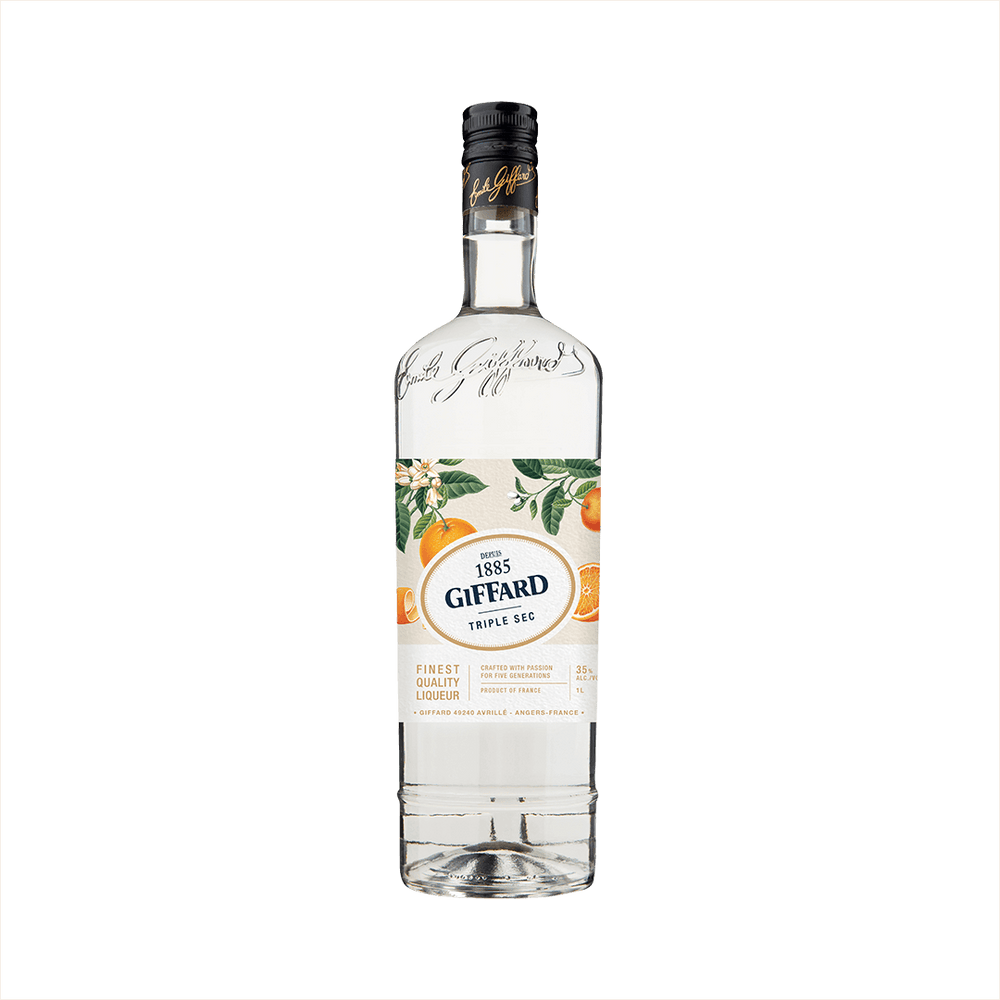 A clear tall bottle of triple sec with a beautifully illustrated label featuring oranges and orange leaves. The label reads 1885 Giffard Triple Sec