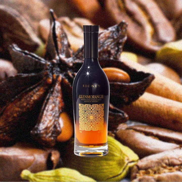 Bottle of Glenmorangie Signet Single Malt Scotch Whisky over backdrop of spices.