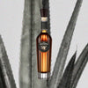 Bottle of Gran Centenario Leyenda Extra Anejo Tequila over backdrop image of agave.
