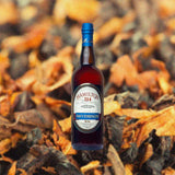 Bottle of Hamilton Navy Strength 114 Proof Rum over backdrop image of leaves or something that looks like leaves.