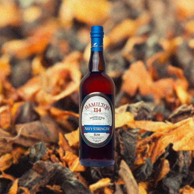 Bottle of Hamilton Navy Strength 114 Proof Rum over backdrop image of leaves or something that looks like leaves.