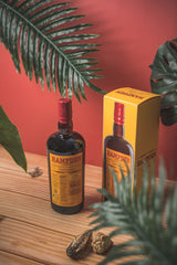 Hampden bottle and box on a wooden surface with plants